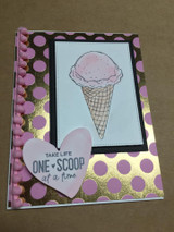 Card with a single scoop cone over a purple-and-gold polka-dot background.