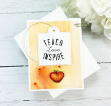 "Teach Love Inspire" tag on a peach and orange distress-inked card with a red apple.