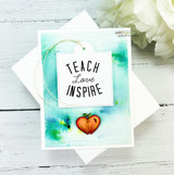 "Teach Love Inspire" tag on a teal and green distress-inked card with an apple.