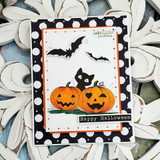 Black polka-dot card with an orange frame: two colored jack-o'-lanterns with a black kitty peeking between them, bats flying overhead, and a “Happy Halloween” strip.