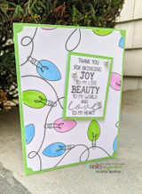 Handmade card featuring the string of vintage Christmas lights framing an A2 card, in rainbow bulbs on white, stamped with 'May the light and joy of the season be yours'.