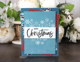 'Merry Christmas' on a blue-and-red patterned layered card.