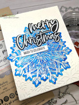 Snowflake cluster with 'Merry Christmas, much to celebrate' on an embossed card.