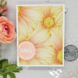 A full-panel daisy background stamped in red rubber and colored on a handmade card reading "Sending happy thoughts."