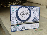 'Merry Christmas' on a white panel with stamped patterned trees and red bow.