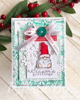 Card with a single bundled gnome, snowflake die-cuts and 'Season's greetings.'