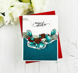 Card with a teal-and-red winter swag of florals and pinecones and 'Winter wishes.'