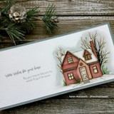Handmade card featuring a cozy home framed by snowy evergreens, with the sentiment "Warm wishes for your home."