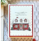 A cozy home framed by snowy evergreens stamped in red rubber and colored on a handmade card reading "May your home be filled with the wonder and joy of the season."