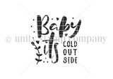 Black-and-white bold word-art stamp reading 'Baby it's COLD OUTSIDE' with tiny plant and heart accents, from the itty bitty collection.