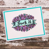 The floral wreath in purple on a cream card framed with a bright teal border.