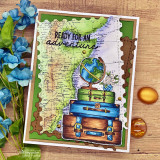 Card with the colored map, a globe, stacked vintage suitcases and blue blossoms, 'ready for an adventure.'