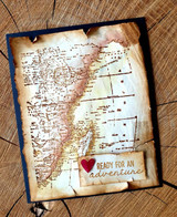 Vintage-style card with the sepia map, a red heart and a 'ready for an adventure' banner.