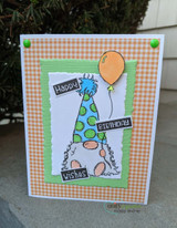 Orange gingham and green layered card: the gnome in a green and blue polka-dot hat holds an orange balloon with the birthday word blocks.