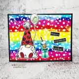 Rainbow-striped panel with white dots: the gnome in a red spotted hat with a green balloon, a cupcake and “Happy Birthday Wishes.”