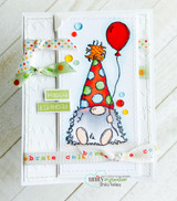 White embossed card with ribbon and buttons: the gnome in an orange dotted hat holds a red balloon over a “celebrate” alphabet strip.