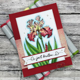Deep red card with a stitched white panel: the iris colored coral and gold beside a “be just breathe” banner, markers alongside.