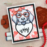 Pink heart card with the white puppy holding an 'I woof you' heart, red rubber stamps beside.