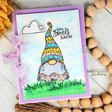 Jeanie Hays' bunny-eared gnome holds an Easter egg in the grass with 'Happy Easter,' a red rubber spring stamp shown on a handmade card.