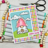 Jeanie Hays' bunny-eared gnome holds an Easter egg in the grass with 'Happy Easter,' a red rubber spring stamp shown on a handmade card.