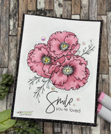 Card with purple pansy-style blooms, stamped 'Smile you're loved.'