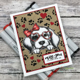 Kraft card with the paw print background in black, a puppy in a heart-glasses bow, and 'miss you'