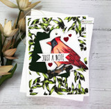 Card with a red cardinal in a leafy wreath and 'just a note.'