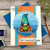 Beach gnome with a crab and star on a blue scalloped panel, 'Don't worry, beach happy,' orange striped card.