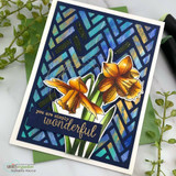 Card with a deep blue and teal woven stencil background, bright golden daffodils coloured in the foreground and a gold embossed wonderful greeting on a strip.