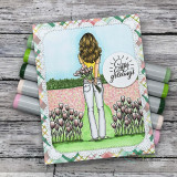 Easter card with the girl holding purple tulips beside a tulip garden path and an 'Easter greetings' circle sentiment.