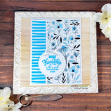 Card with blue wonky stripes behind delicate florals and a friendship sentiment.