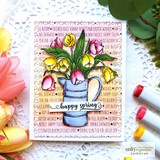 Card with a spring text background behind a watering can of tulips and 'happy spring.'