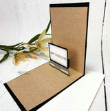 Kraft easel card standing open, with a small stamped laptop at the base showing happy Father's Day on the screen.