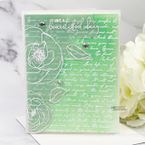Sample card with the blooms and leaves heat embossed in white over a green blended script background, stamped 'Have a beautiful day' and finished with clear gems.