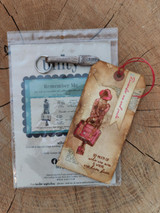 Packaged Remember Me stamp with a tag of the traveler girl.