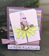 Purple striped card with the gnome in a lilac hat on a yellow daisy, tied with a pink ribbon under 'Let The Little Things Be Enough.'