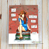 Card with BraeLynn colored in a blue dress on vintage suitcases against a red brick background.