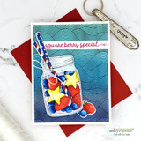 Card with the wave background stamped in deep teal across the panel, a jar of red, white and blue candy stars coloured on top and a script berry special greeting.