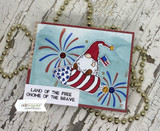 Card with the patriotic gnome on a blue panel with red fireworks and 'land of the free gnome of the brave.'