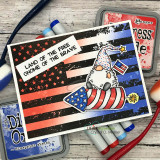 Card with the patriotic gnome over a red-striped flag background beside markers.