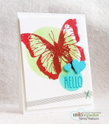 The butterfly in red and green on a clean white card with a teal circle.