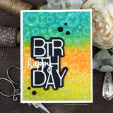 Card with the hearts background in teal, orange and yellow ombre behind a large black and white die-cut birthday word