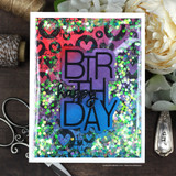 Shaker card with the hearts background in red, purple and blue under green sequins and a layered birthday word