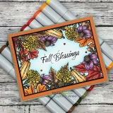 Handmade card made with Unity Stamp Co’s Blessings of Fall {border backgrounds} red rubber stamp set — a full A2 border-background stamp of autumn flowers, leaves, sunflowers, mums and wheat framing the card — stamped and colored, with the sentiment “Fall Blessings”.