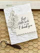 Kraft card with an embossed leafy panel and 'Just a little note to say Thank you' in black script.
