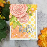 Pink roses and lemons, 'hello,' on a bright card.