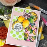 Lemons and lemon slices with blossoms on a pink polka-dot card, with "Start afresh."