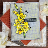 Sample card with the gladiolus colored bright yellow, layered on a grey floral print panel with a black sentiment strip reading 'happy birthday'.