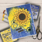 Blue mixed-media card with the sunflower over Distress Oxide inks.