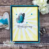 Card with a bright blue butterfly over a sunburst, 'happy thanksgiving.'